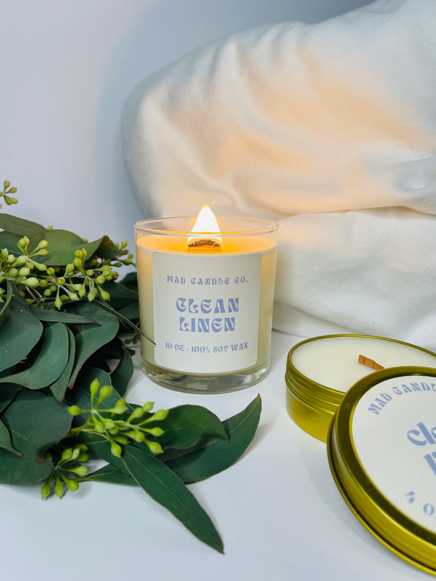 Clean Linen 10oz Glass Jar Soy Candle and 4oz travel tin front view, natural soy candle shop, scented non-toxic soy candle, wholesale handmade candles, soy candle care